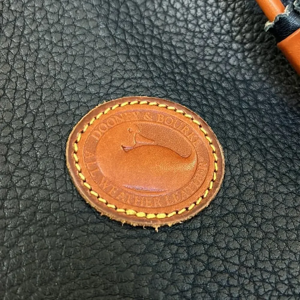 Dooney & Bourke tassel bucket bag blue pebbled leather tan accent gold hardware